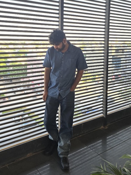 Anukul Pandey leaning against window blinds